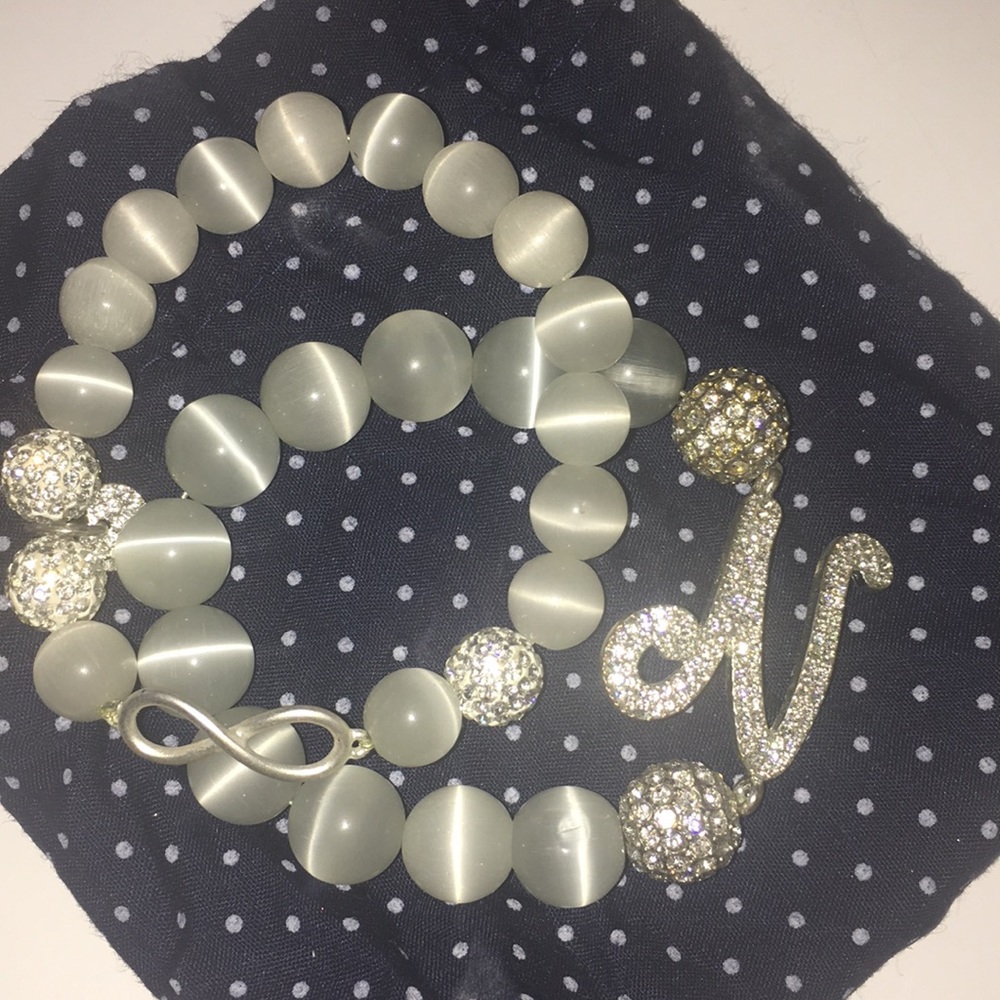 White Bead N initial and infinity bracelets.
